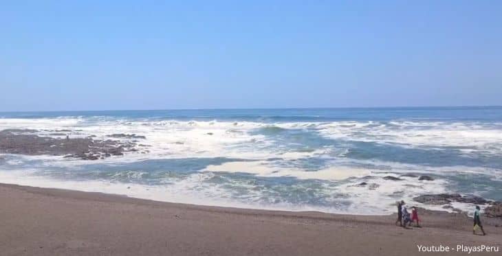 4 personas caminando por las orillas de la playa Boca del Río en Tacna.